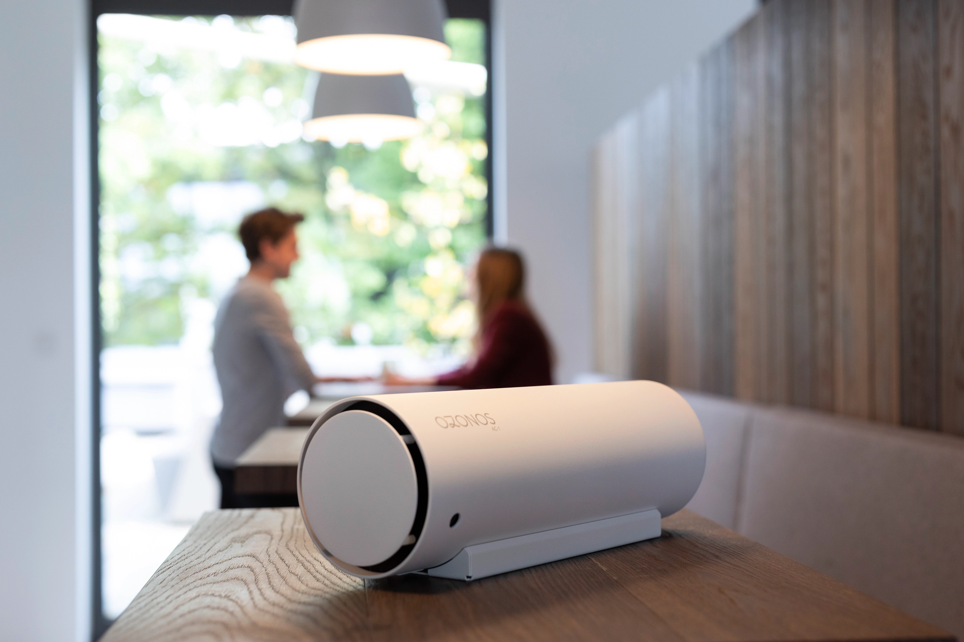 Clean fresh air in a meeting room provided by a silver OZONOS air filter